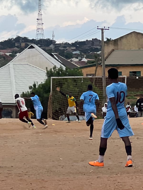 Afternoon football on a dirt pitch in Jos, Nigeria