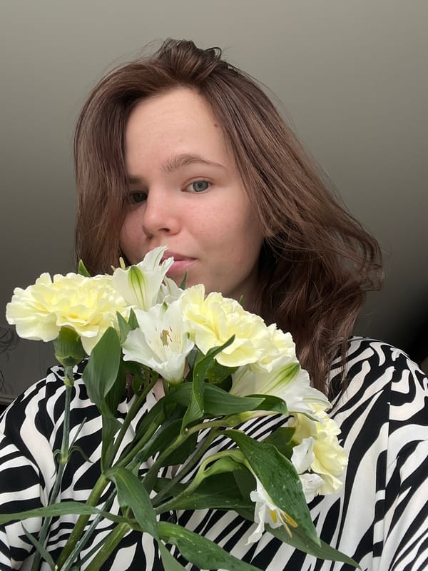 Woman takes mirror selfies with flowers in Chaikovsky