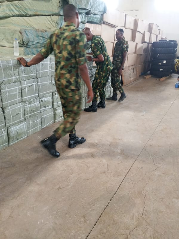 Military personnel observed handling packaged goods in warehouse facility