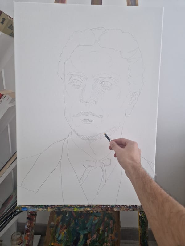 Artist sketches male portrait on easel indoors