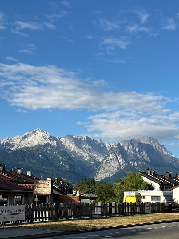 Morning drive through Garmisch-Partenkirchen with alpine views and a croissant