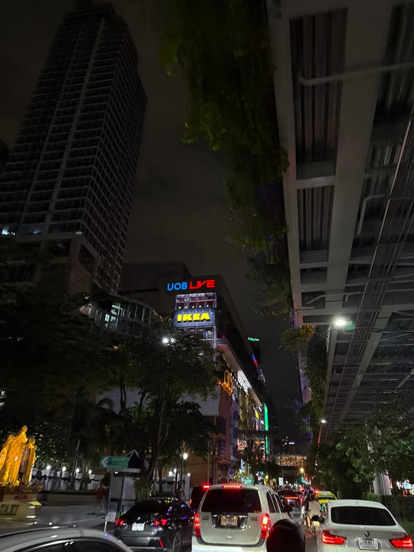 Ground-level nighttime street scene in central Bangkok