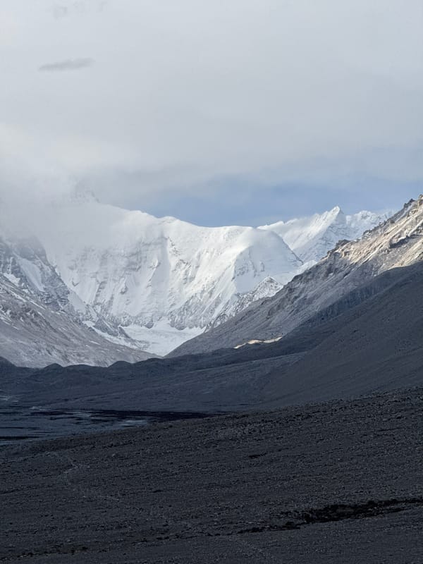 Snow-capped mountains observed through clouds in Tashi Dzom, China