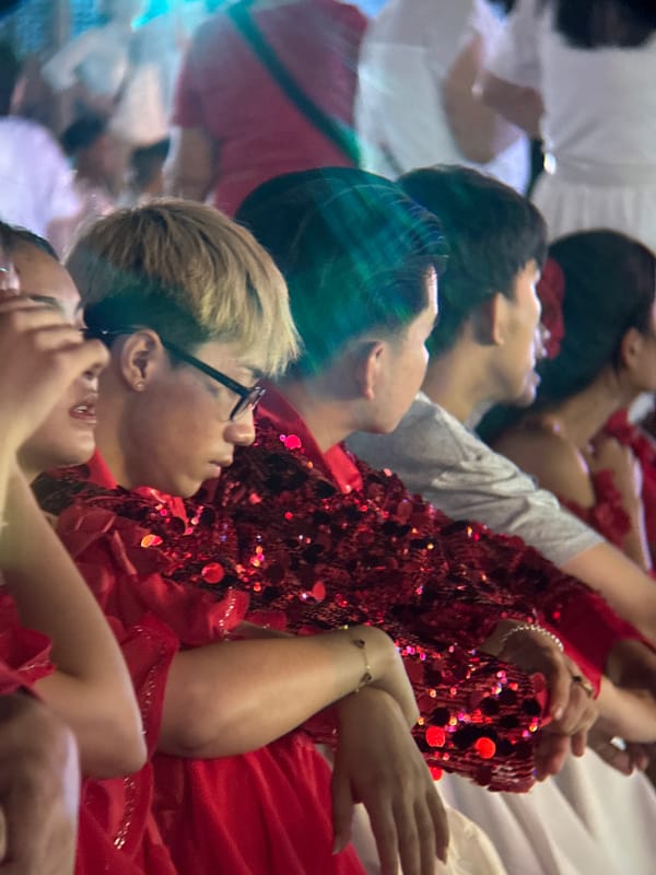 Red sequined performers light up a Nha Trang beach festival night