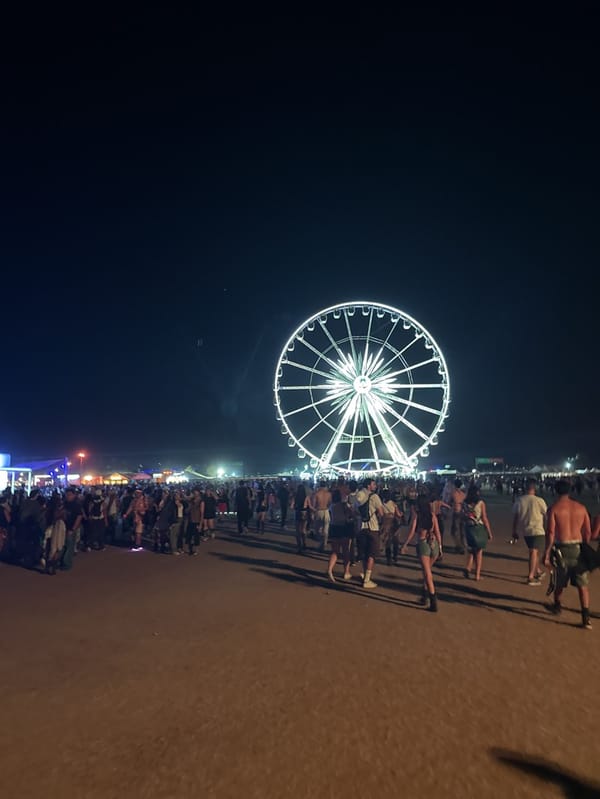 Coachella Festival nighttime scenes captured with illuminated Ferris wheel