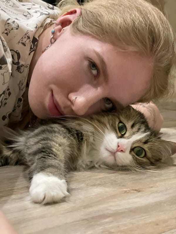 Woman and cat share quiet moment in Izhevsk apartment