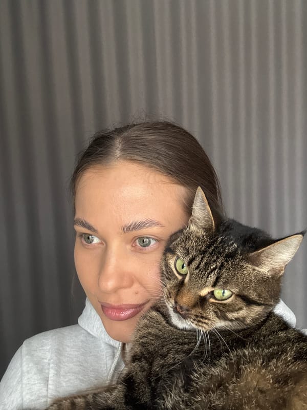 Woman poses with tabby cat in casual photo session