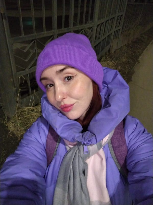 Woman in purple winter attire photographed on Izhevsk street