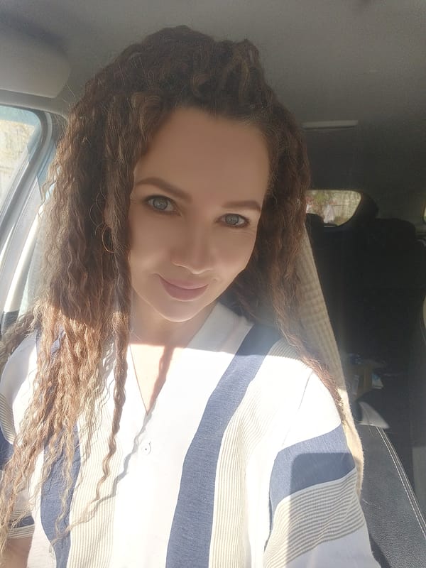 Woman in striped shirt photographed inside car