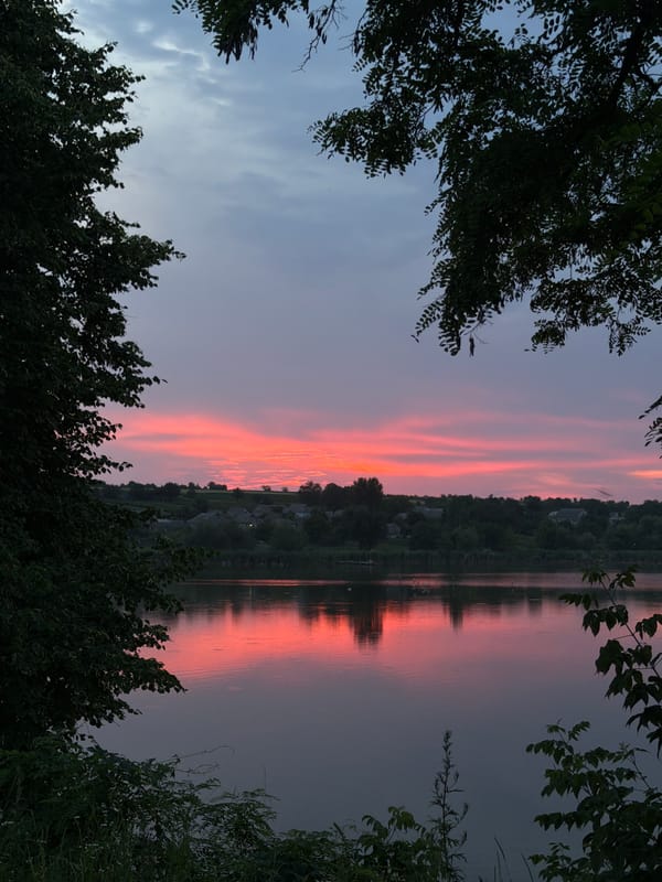 Dusk skies, still water, and worn rural buildings