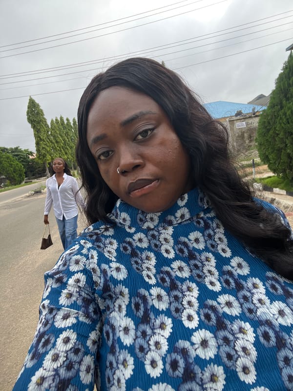 Quiet morning street activity across a residential Abuja neighborhood.