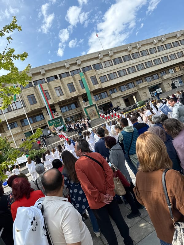 Crowd gathers at flag-decorated government building in Shumen, Bulgaria