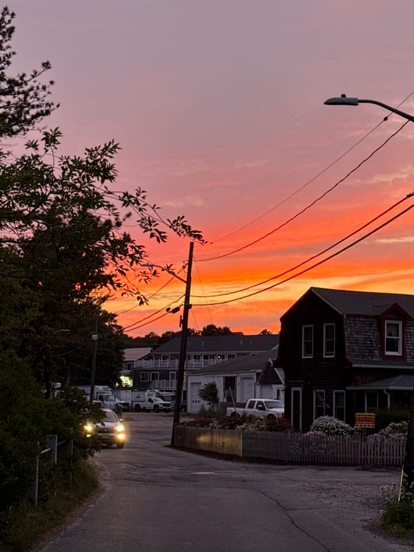 Provincetown street glows under a vivid summer sunset