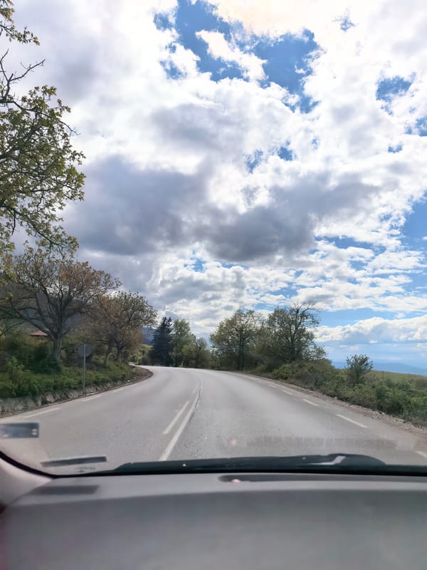 Vehicle travels curved road in Sapareva Banya, Bulgaria