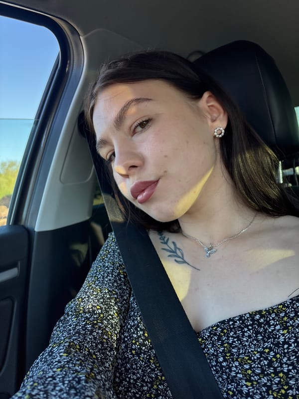 Woman in floral dress observed as car passenger in Perm
