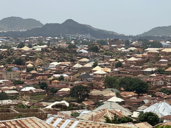 Aerial views capture dense residential Jos neighborhood with metal roofs