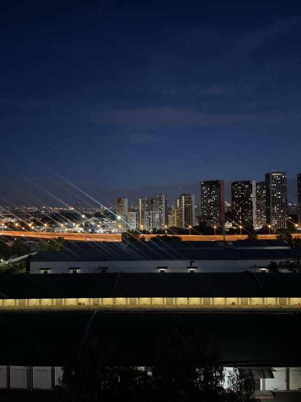 Moscow skyline at night, industrial buildings lit up in foreground