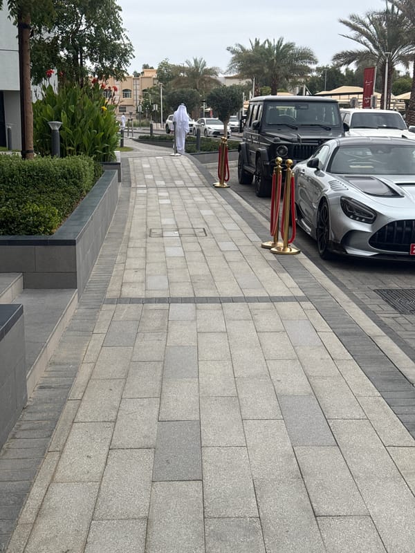 Luxury cars line Al Jimi street with rope barriers