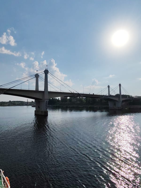 Barge crew maintains deck while passing under Kimry bridge