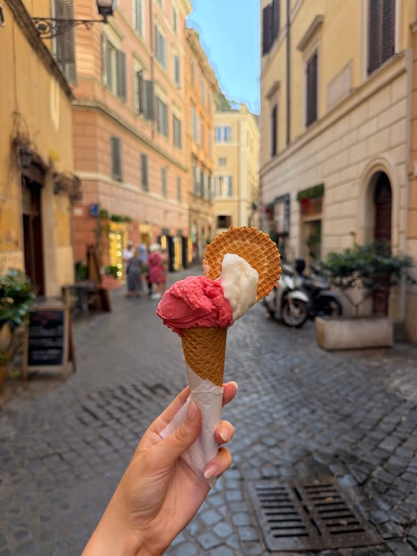Person enjoys gelato on Rome street