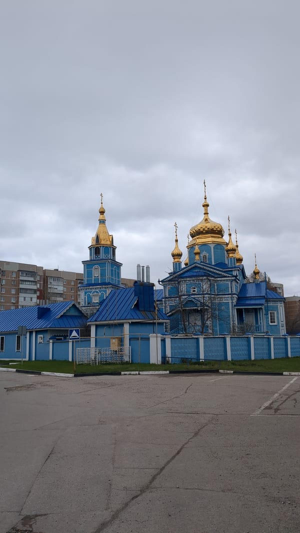 Blue wooden Orthodox church with golden domes documented in Ulyanovsk
