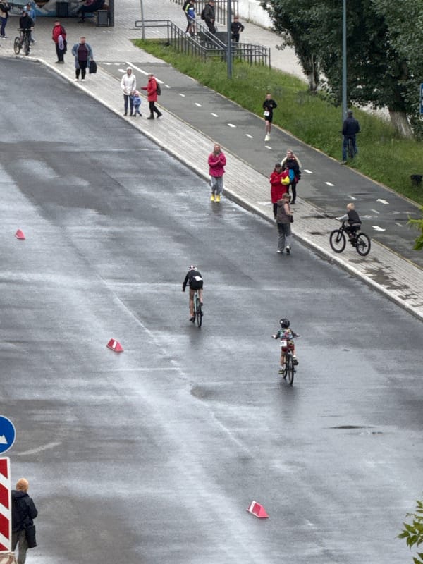 Cyclists roll through wet Votkinsk streets during a morning event