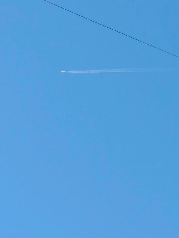 Aircraft leaves contrail over Kardzhali Bulgaria morning sky