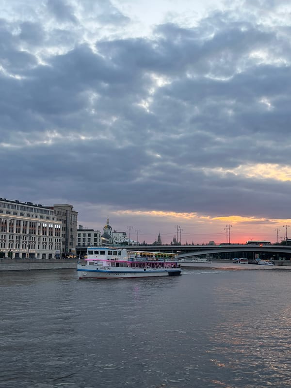 Moscow River at dusk, cruise ship and motorboat in frame