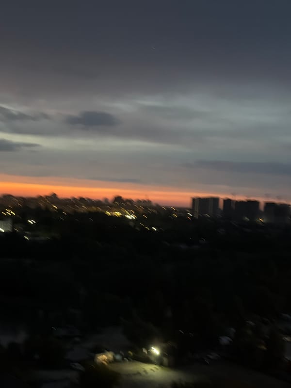 Kyiv dusk views and snack spread from a high-rise apartment