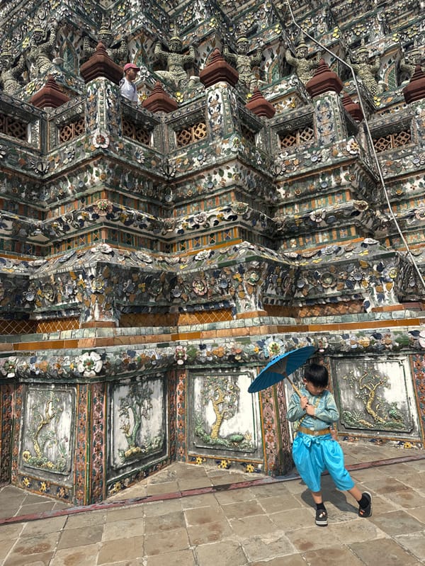 Morning visitors pose at Bangkok's Wat Arun Temple
