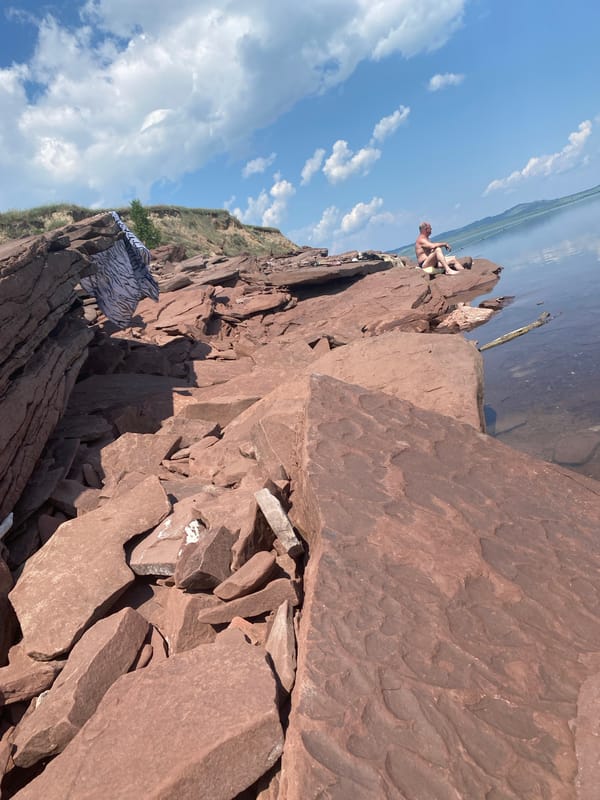 Early morning fishing session on red rocks near Ust'-Erba