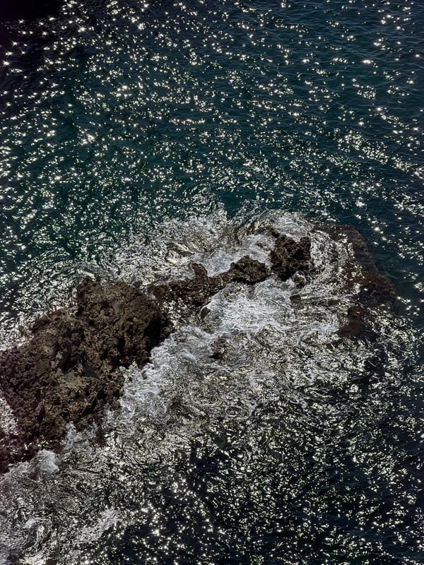 Morning sunlight illuminates rocky coastline near Prijevorac, Montenegro