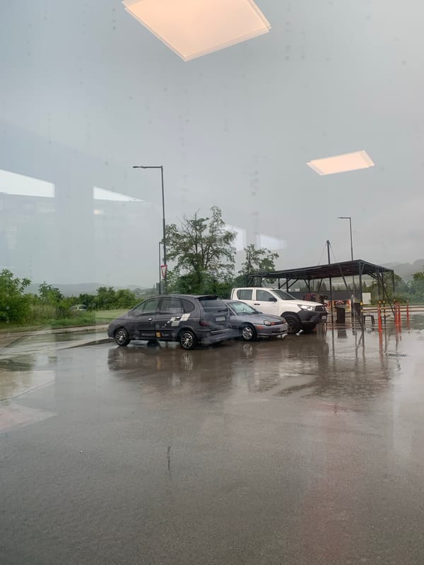 Rainy day viewed through reflective window captured by witness