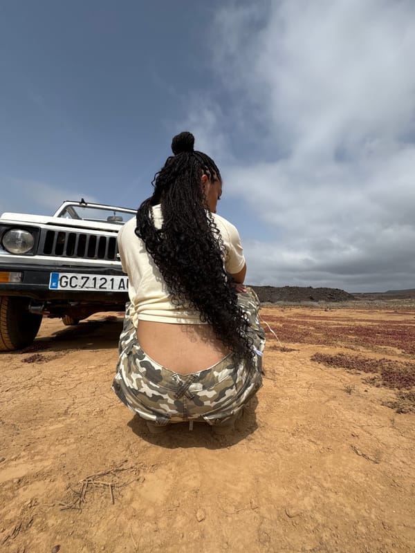 Person with braids spotted at white SUV in Tinajo desert