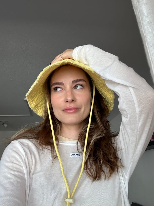 Woman poses for portraits in yellow hat in Kiel