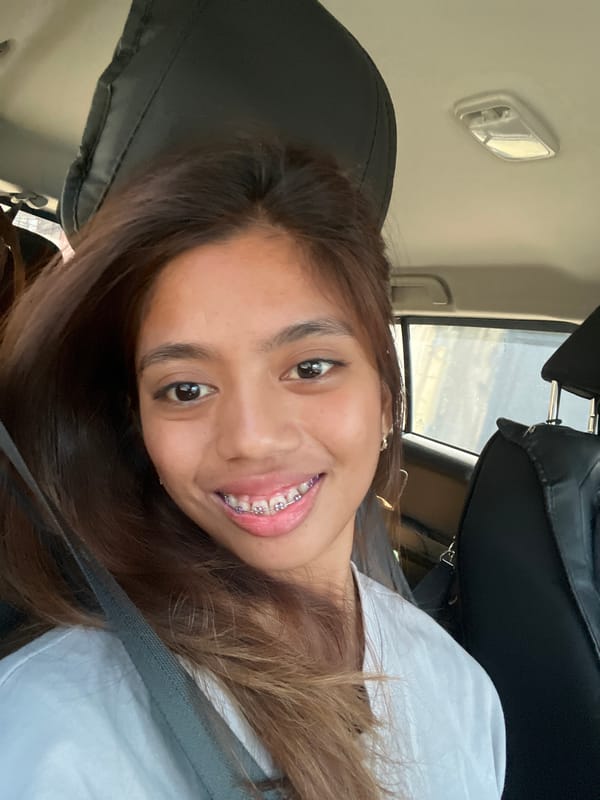 Woman takes playful selfies during early morning car ride