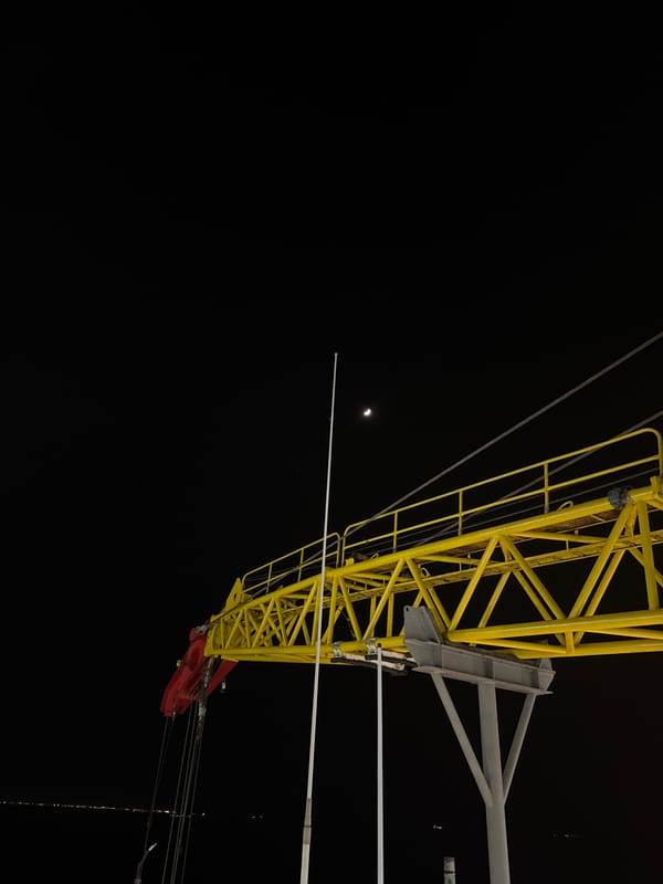 Industrial crane or drilling rig photographed at night in Italy