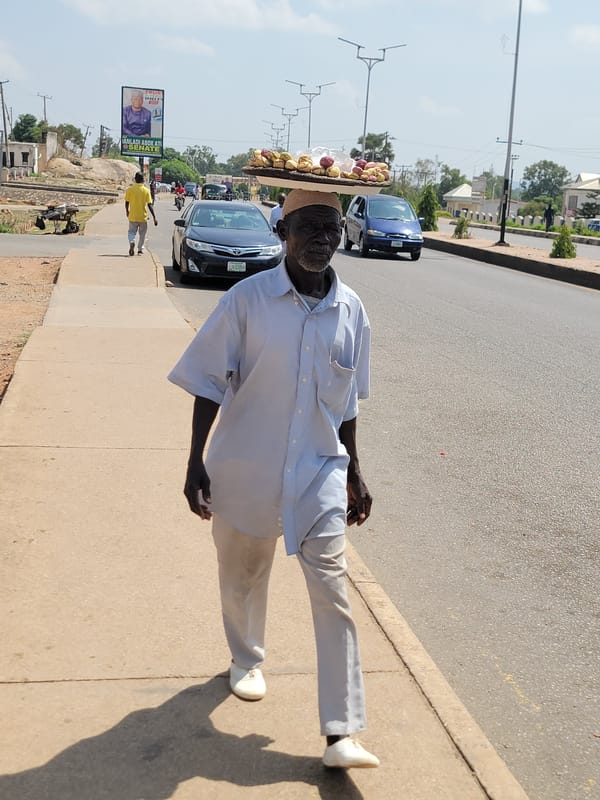 Daily life unfolds on Jos streets with vendors, residents