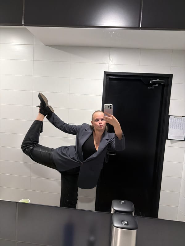 Woman takes bathroom selfies in gray suit, Izhevsk
