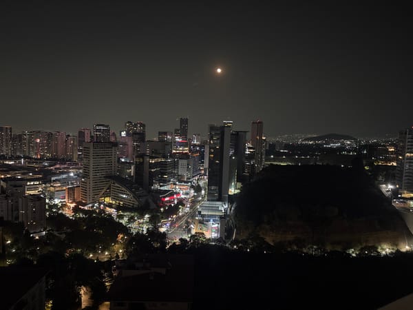 Aerial nighttime view captures moonlit Mexico City skyline