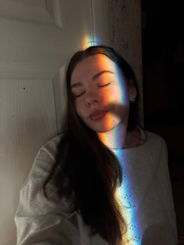 Person resting amid colorful lights documented in Perm, Russia