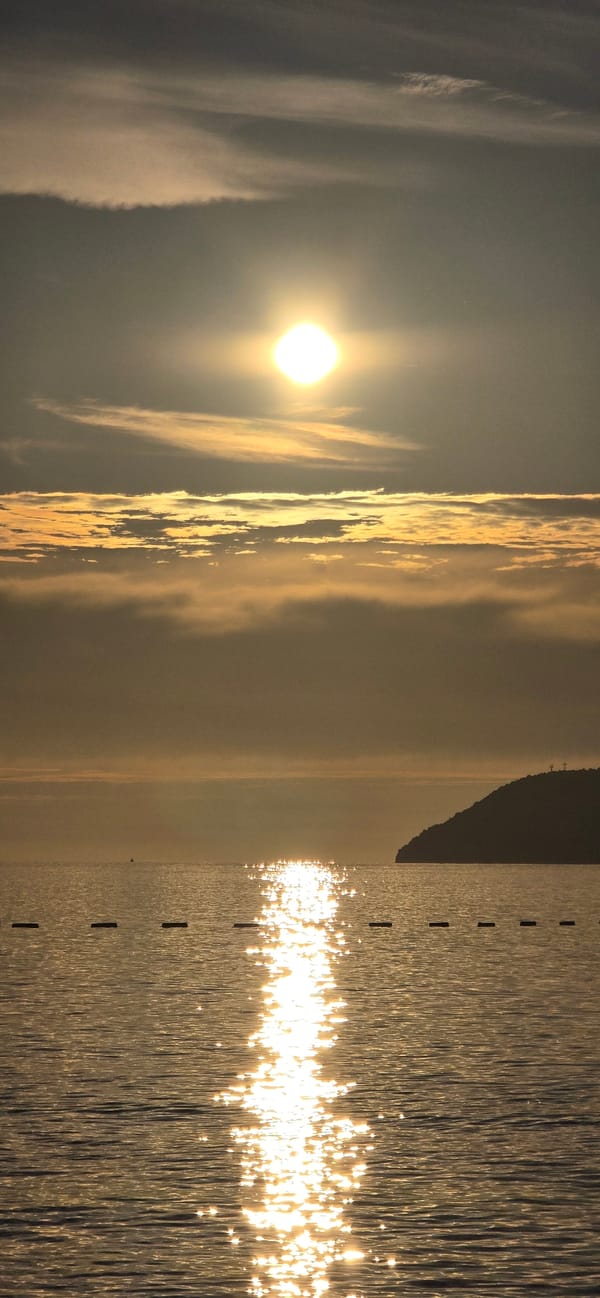 Fishing boat, sailing catamaran spotted during sunset in Bar, Montenegro
