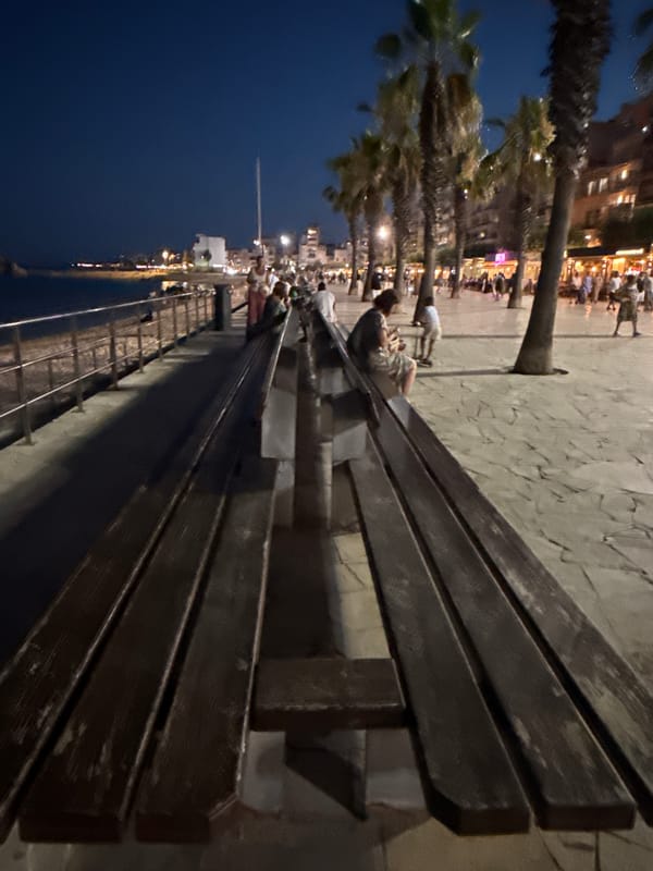 Summer night in Blanes: beach fishing and busy waterfront terraces