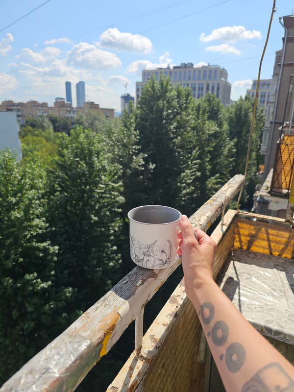 Morning coffee on a weathered Moscow balcony railing