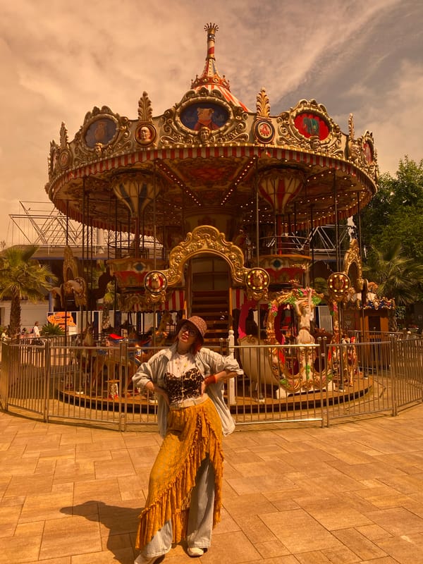Woman in layered outfit visits carousel park in Sochi