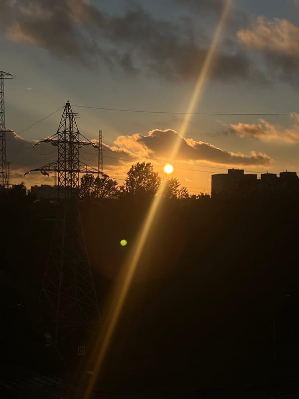 Golden sunset over Saint Petersburg rooftops and power pylons