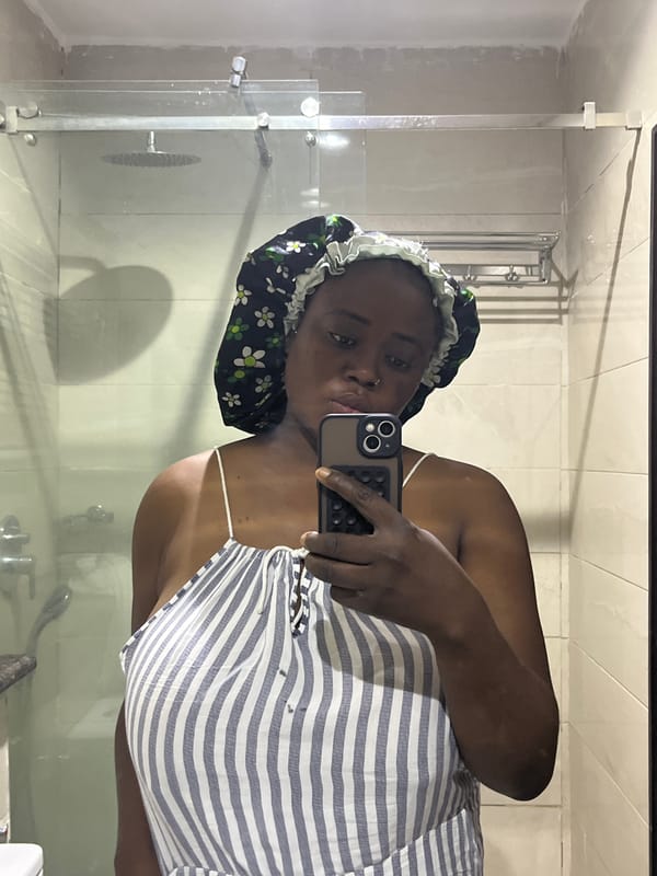Woman takes morning selfies in floral bonnet, Abuja