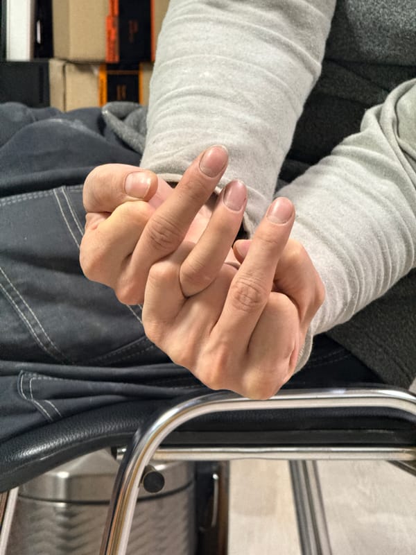 Clasped hands photographed indoors in Chaikovsky, Russia