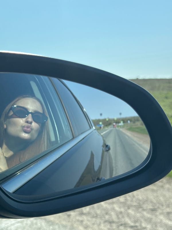 Woman in sunglasses spotted in car mirror, Polozovo Russia