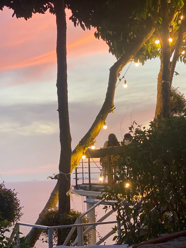 Decorated trees frame sunset sky in Baan Kai, Thailand